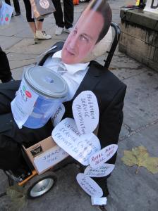 Dummy of David Cameron on trolley with labels attached